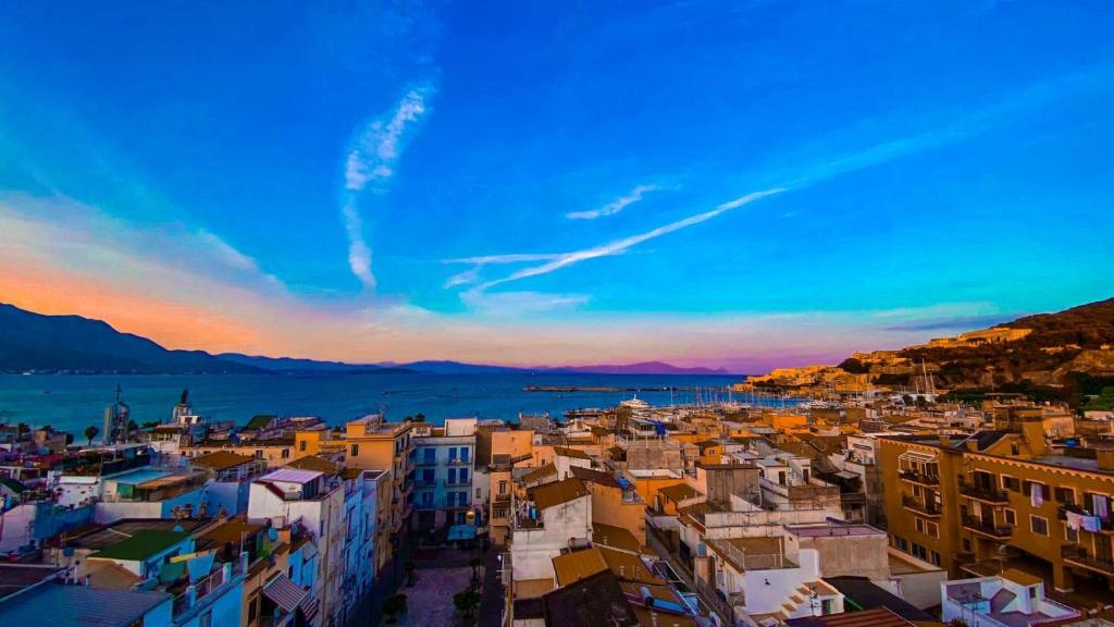 a view of a city at sunset at La terrazza dei colori in Gaeta