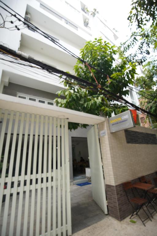 a white gate in front of a house at SaigonOne Serviced Apartment in Ho Chi Minh City