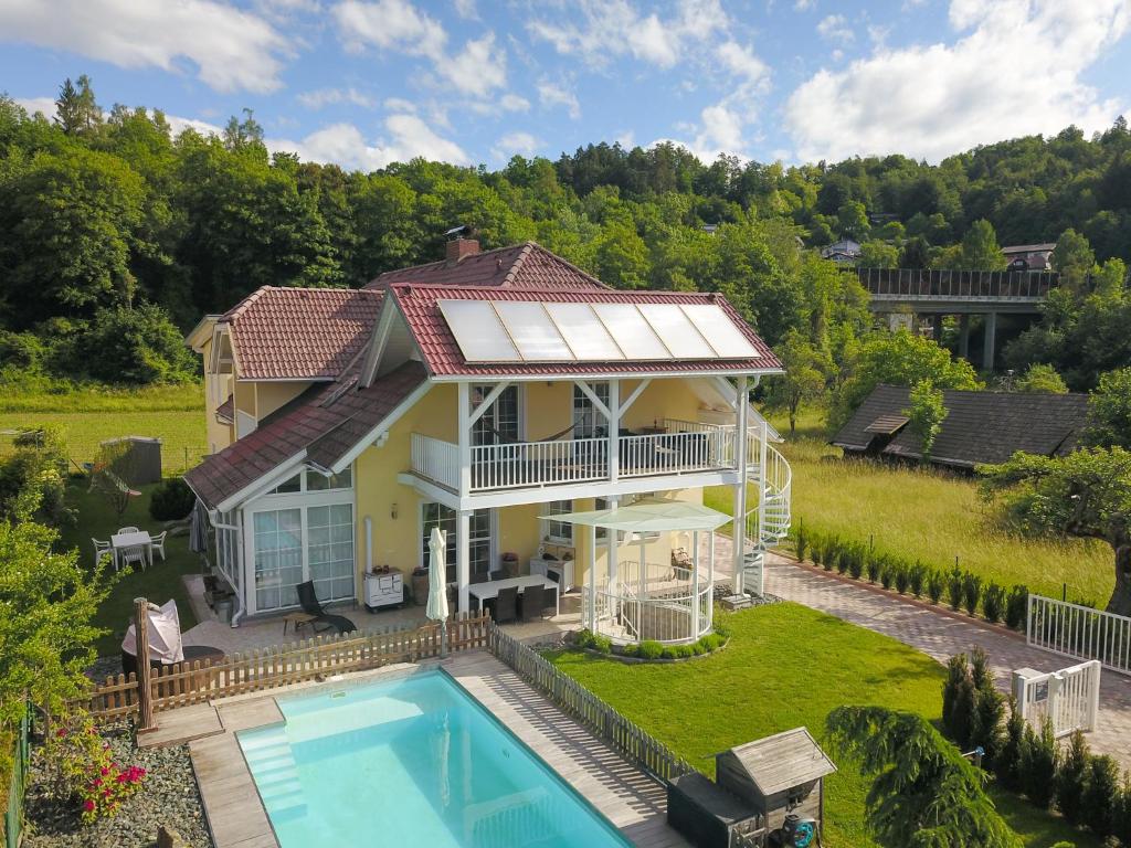 an aerial view of a house with a swimming pool at Villa Schaller - Apartment in Krumpendorf am Wörthersee