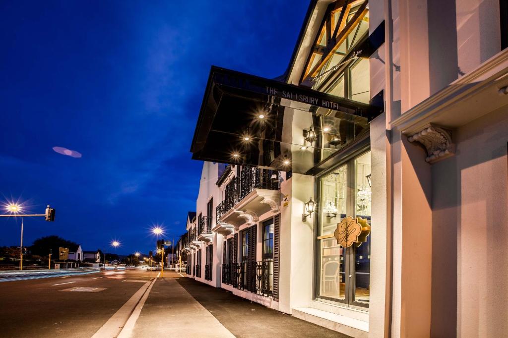 an empty street at night with a building at The Salisbury in Christchurch