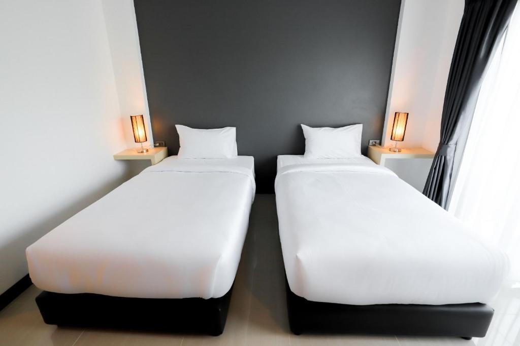 Postel nebo postele na pokoji v ubytování The Rest Hotel - ประจวบ