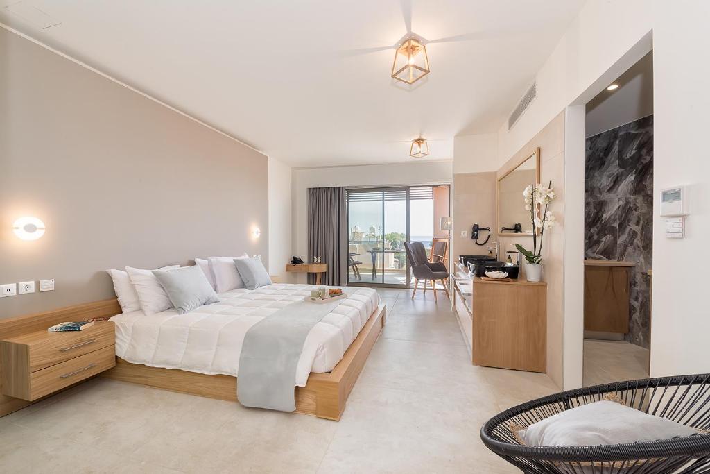a bedroom with a large bed and a living room at Lilium Luxury Suites in Agia Marina Nea Kydonias