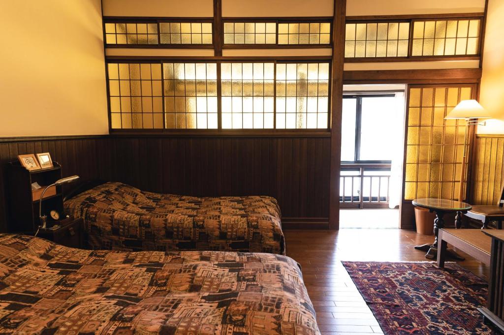 Postel nebo postele na pokoji v ubytování Hotel Hanakoyado