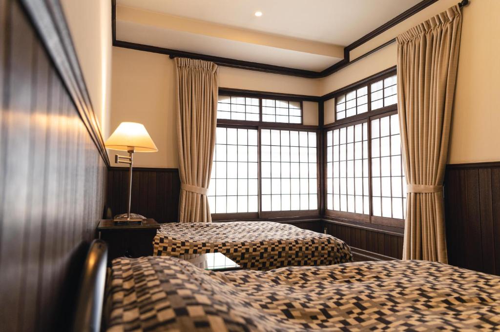 Postel nebo postele na pokoji v ubytování Hotel Hanakoyado
