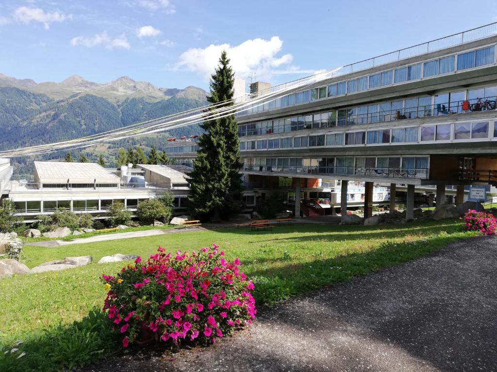a large building with pink flowers in front of it at Marilleva 1400 Appartamenti Montana in Marilleva