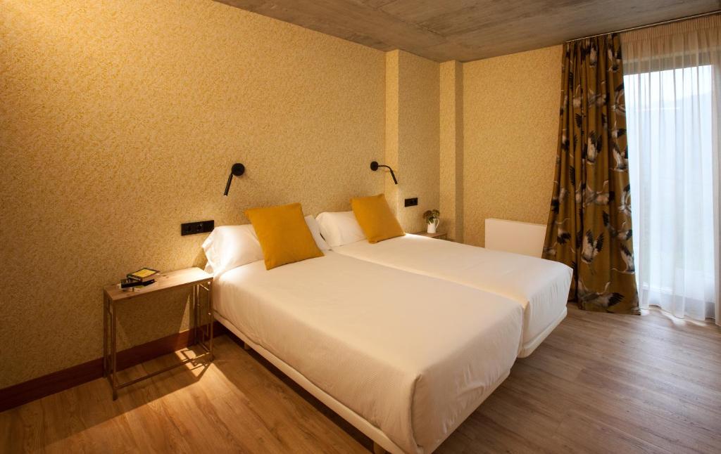 A bed or beds in a room at Eira Gundián