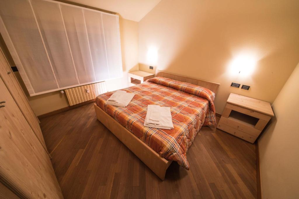 Postel nebo postele na pokoji v ubytování Appartamenti Pirovano Bormio