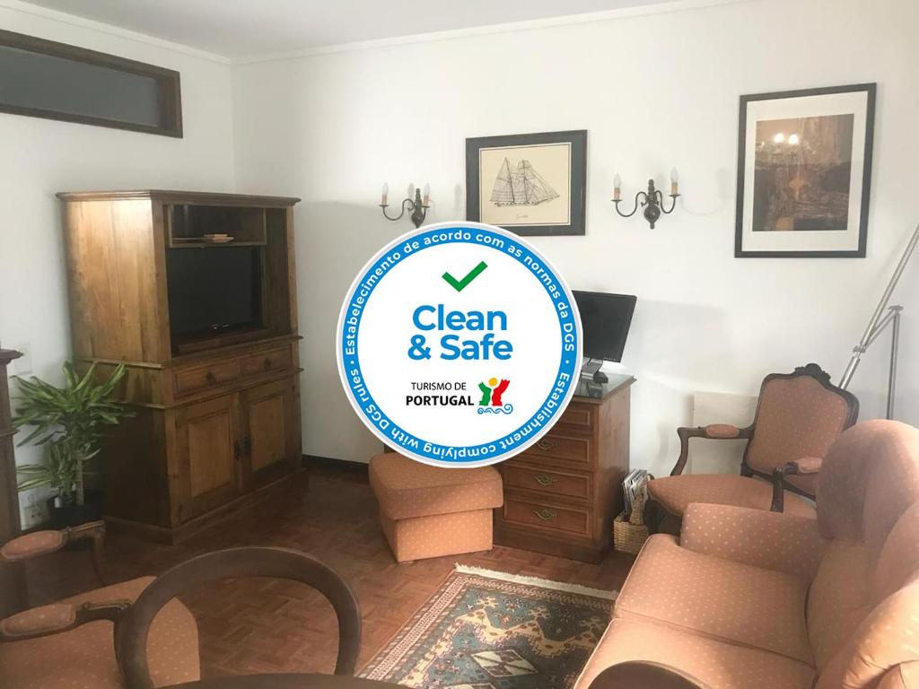 a living room with a sign that says clean and safe at Casa da 25 in Espinho