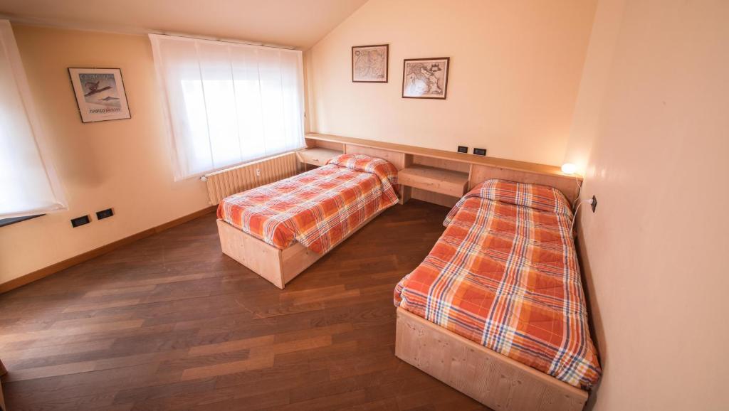 Postel nebo postele na pokoji v ubytování Appartamenti Pirovano Bormio