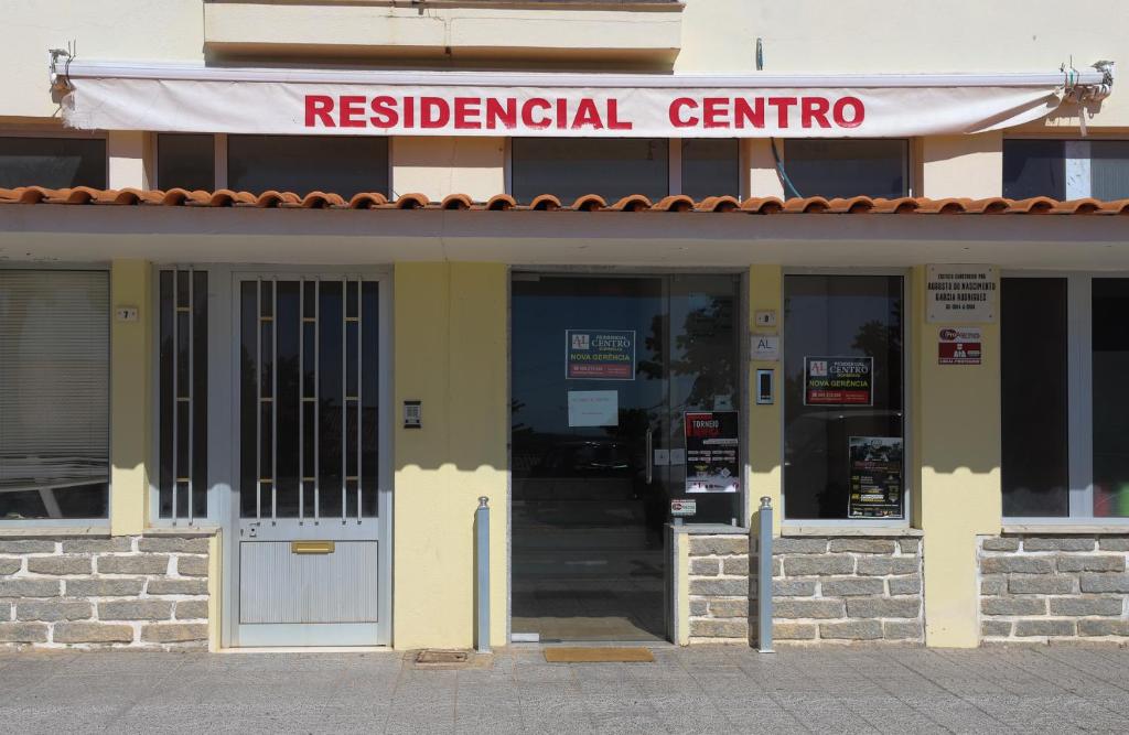 a building with a red federal centre sign on it at Resedencial centro in Vimioso