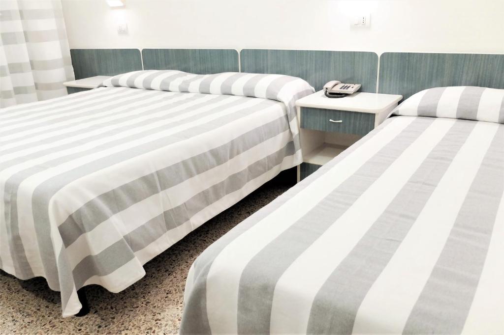 Postel nebo postele na pokoji v ubytování Hotel Aurea