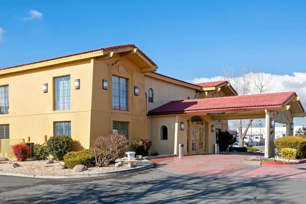 a large yellow building with a red roof at La Quinta Inn by Wyndham Reno in Reno