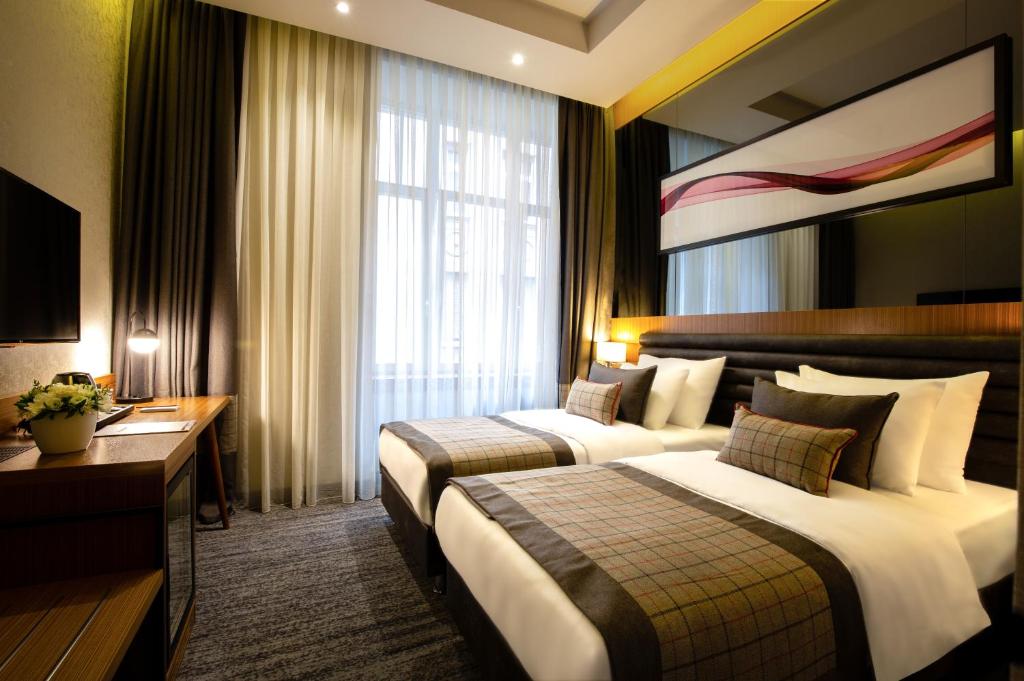 Postel nebo postele na pokoji v ubytování Ramada by Wyndham Budapest City Center