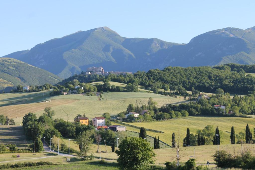 małe miasteczko w dolinie z górami w tle w obiekcie MANSARDA VITI - Sguardo su Frontone - w mieście Frontone