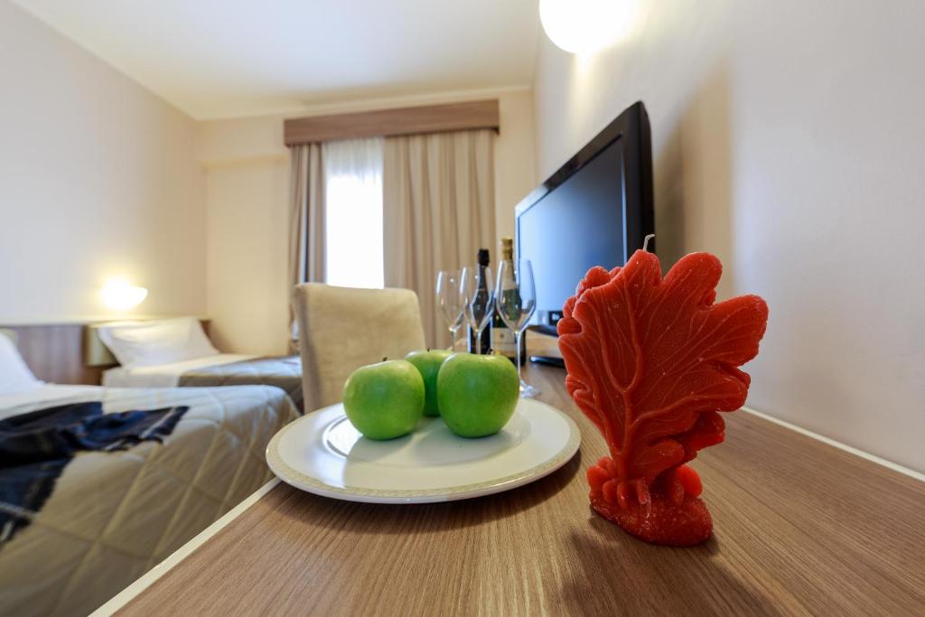 a table with a plate of fruit on it in a hotel room at Hotel Mirasole International in Gaeta