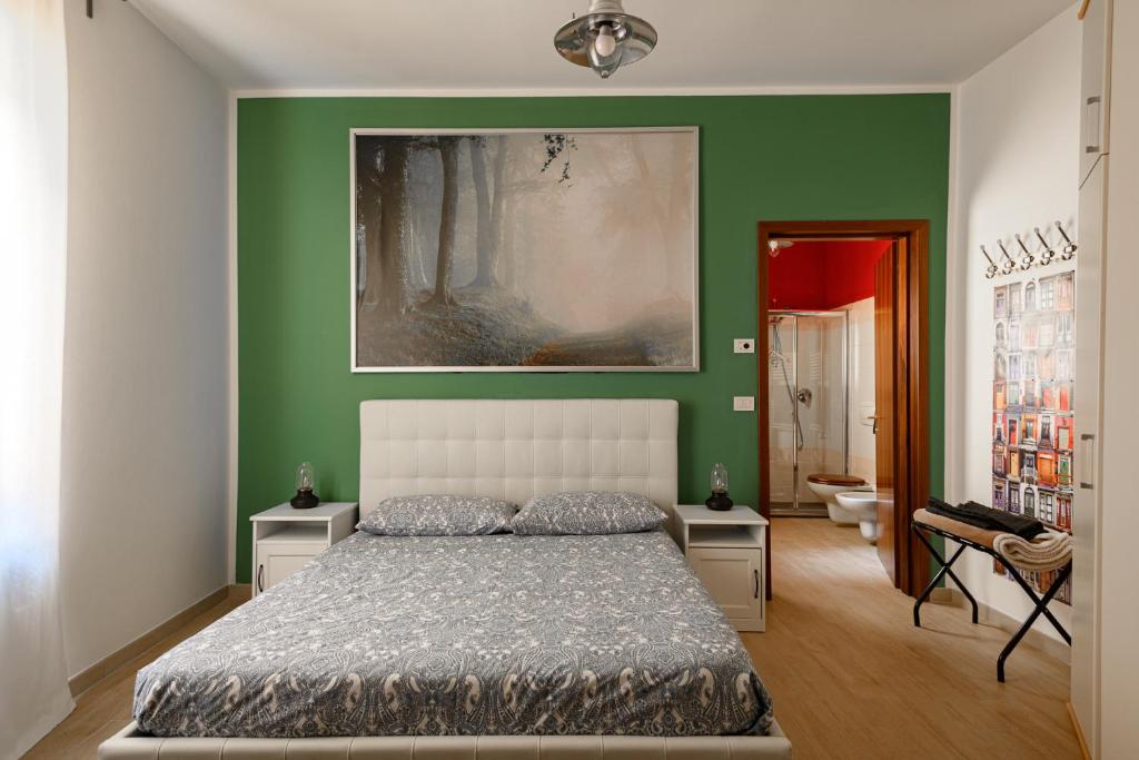 a bedroom with a bed and a green wall at Residence Griffoni in Bologna