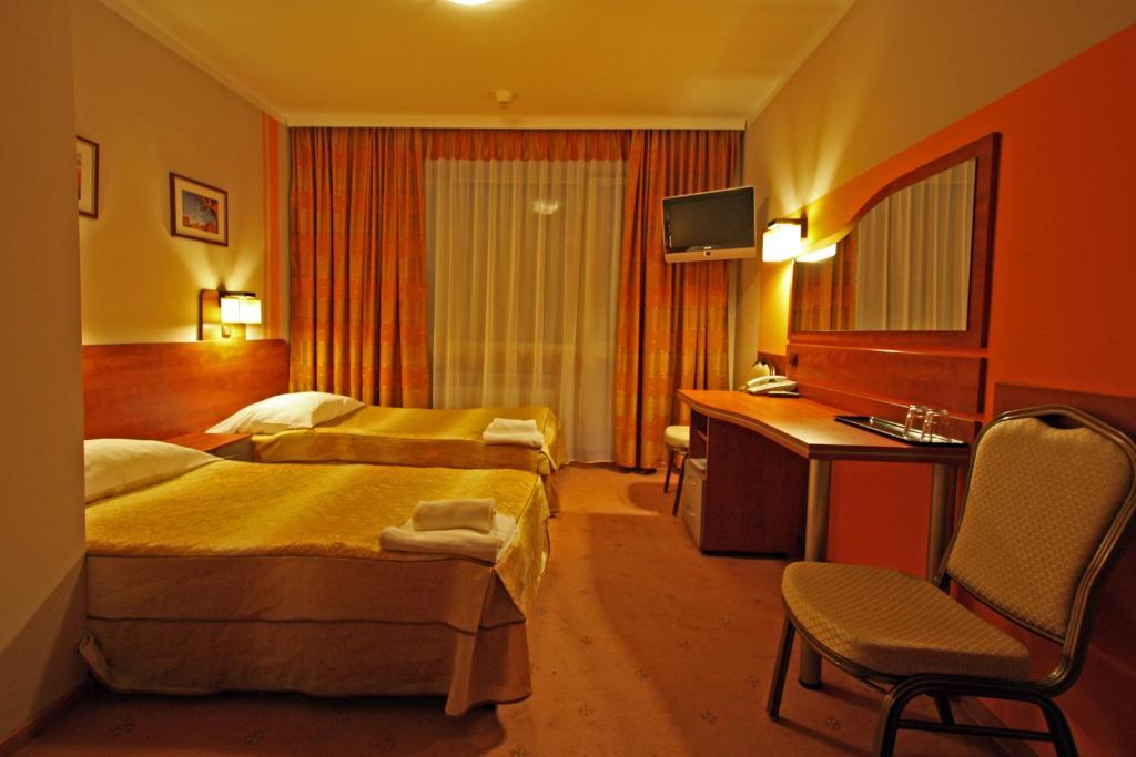 Postel nebo postele na pokoji v ubytování Hotel Orion