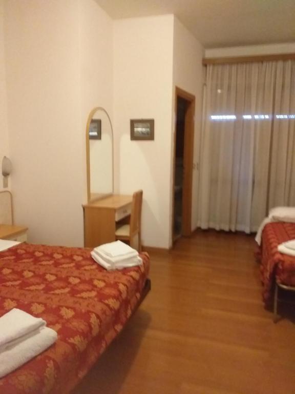 Postel nebo postele na pokoji v ubytování Hotel Rugantino