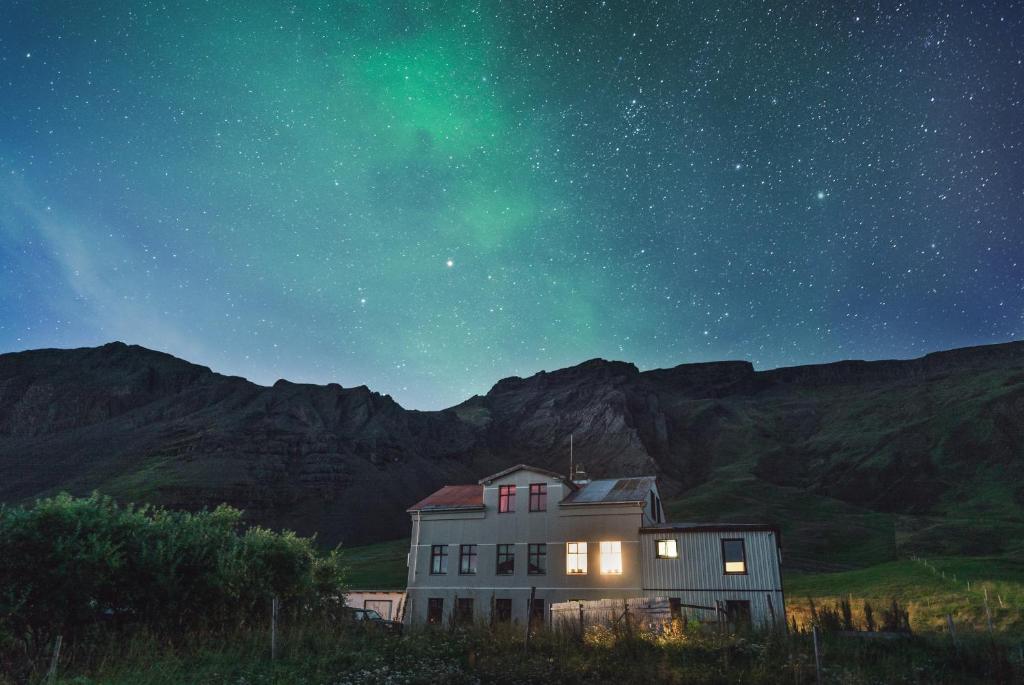 an old house under the starry sky at night at Hvammur 2 Guesthouse in Blönduós