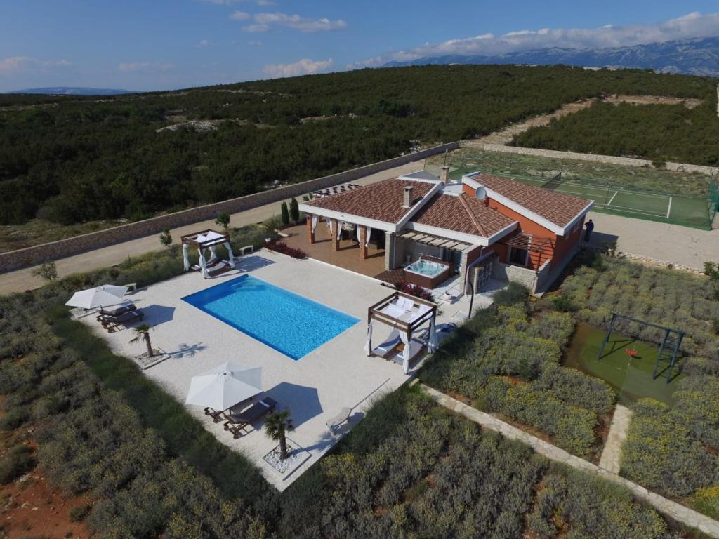 an aerial view of a house with a swimming pool at Villa Melody Novalja in Novalja