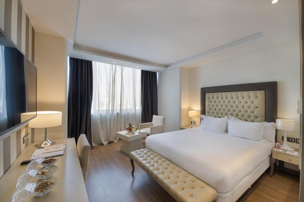 a hotel room with a large bed and a television at Mogador Marina in Casablanca