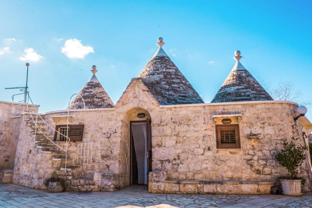 an old stone building with two towers at Trulli Sabrina Resort in Locorotondo