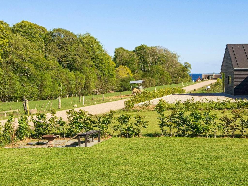un parque con un banco en medio de un campo en 10 person holiday home in Haderslev en Haderslev