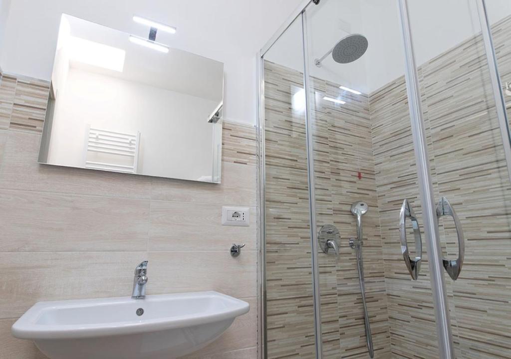 a bathroom with a sink and a glass shower at Hotel Residence Nemo in Brindisi