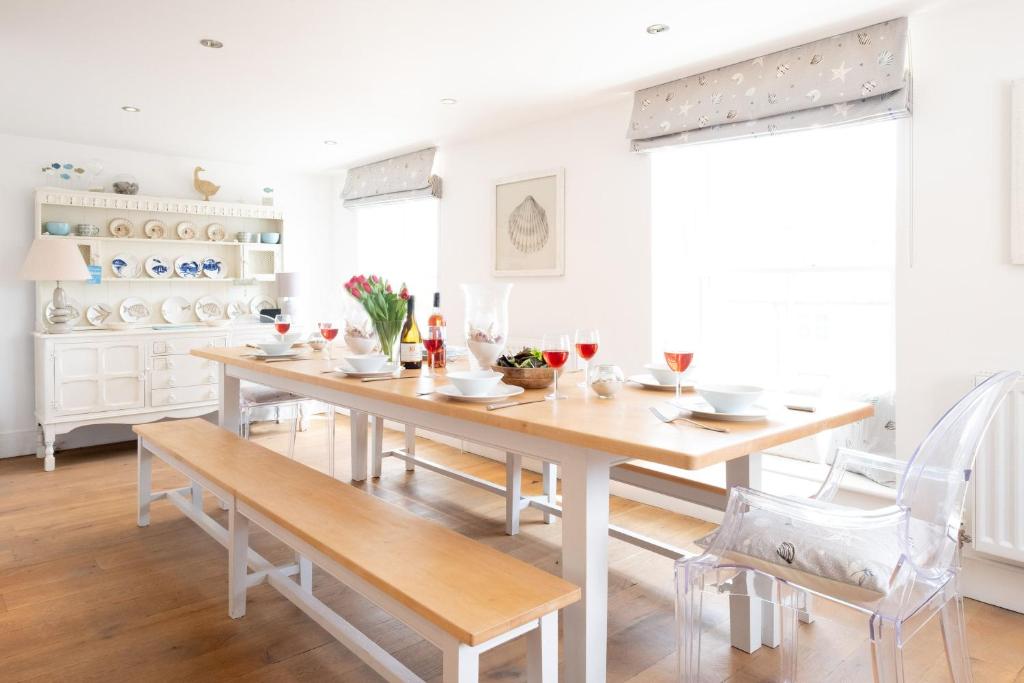 a dining room with a wooden table and chairs at Mansard House in Aldeburgh