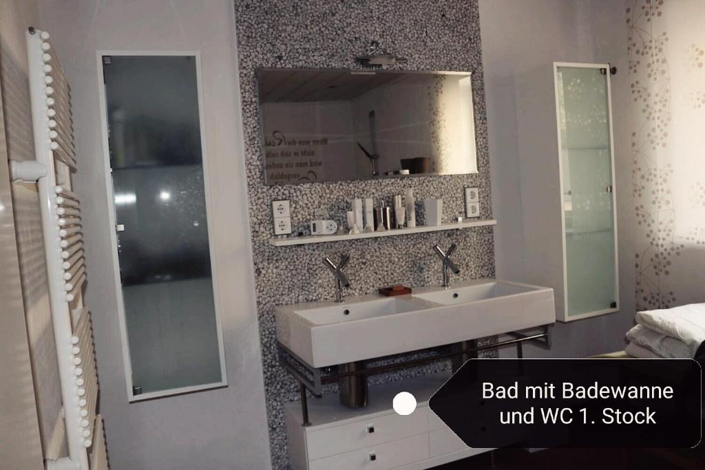 a bathroom with a white sink and a mirror at Haus Berger in Fuschl am See