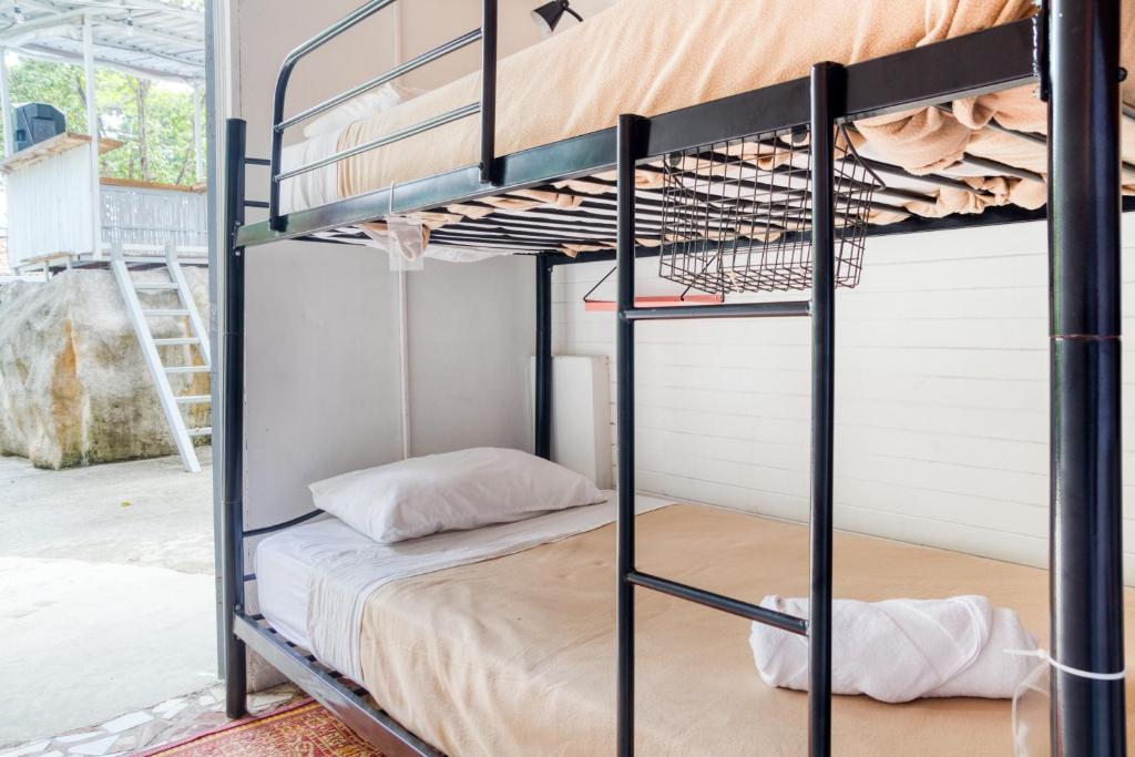 a bedroom with a bunk bed in a room with a window at Selina Puerto Viejo in Puerto Viejo