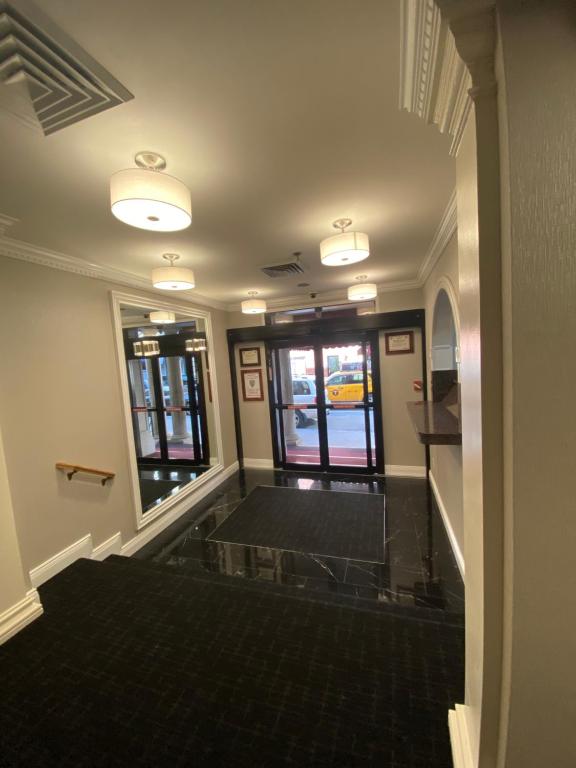 an empty room with a hallway with windows at Hotel 31 Extended Stay in New York