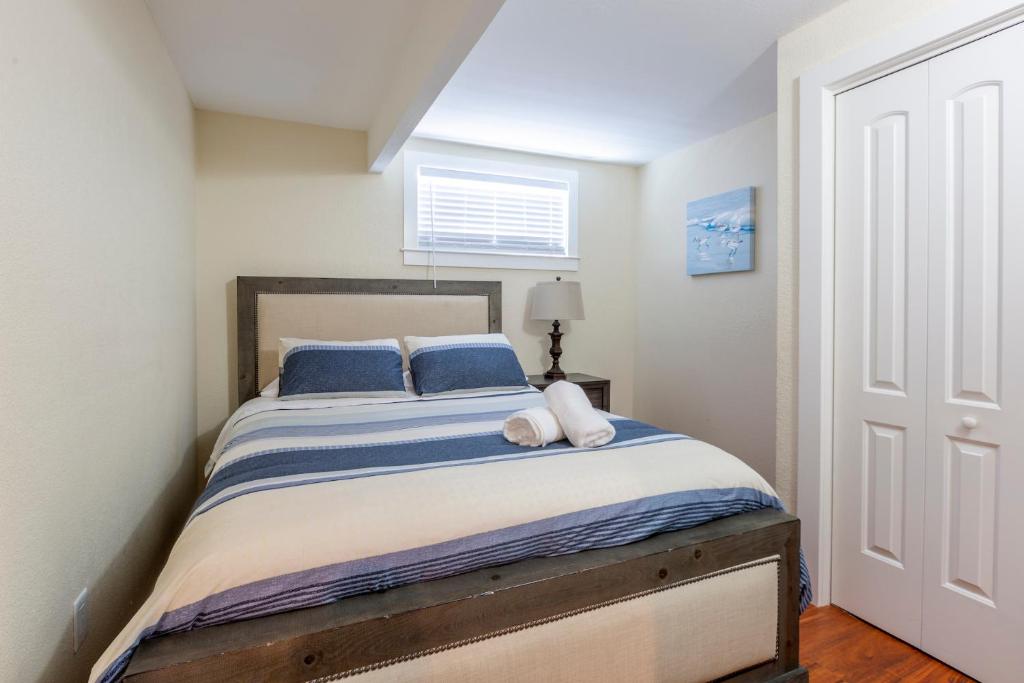 a bedroom with a large bed with blue pillows at @ Marbella Lane 2BR Lower Level House in Downtown San Jose in San Jose