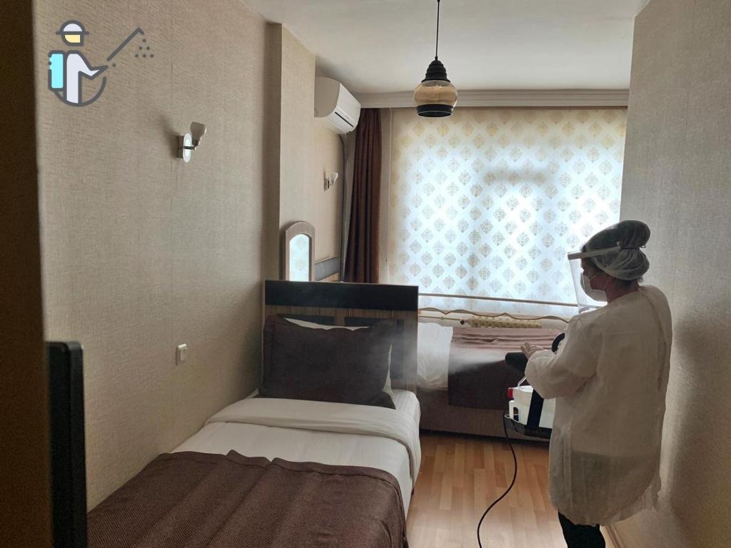 A bed or beds in a room at Cmr Aydogan Hotel