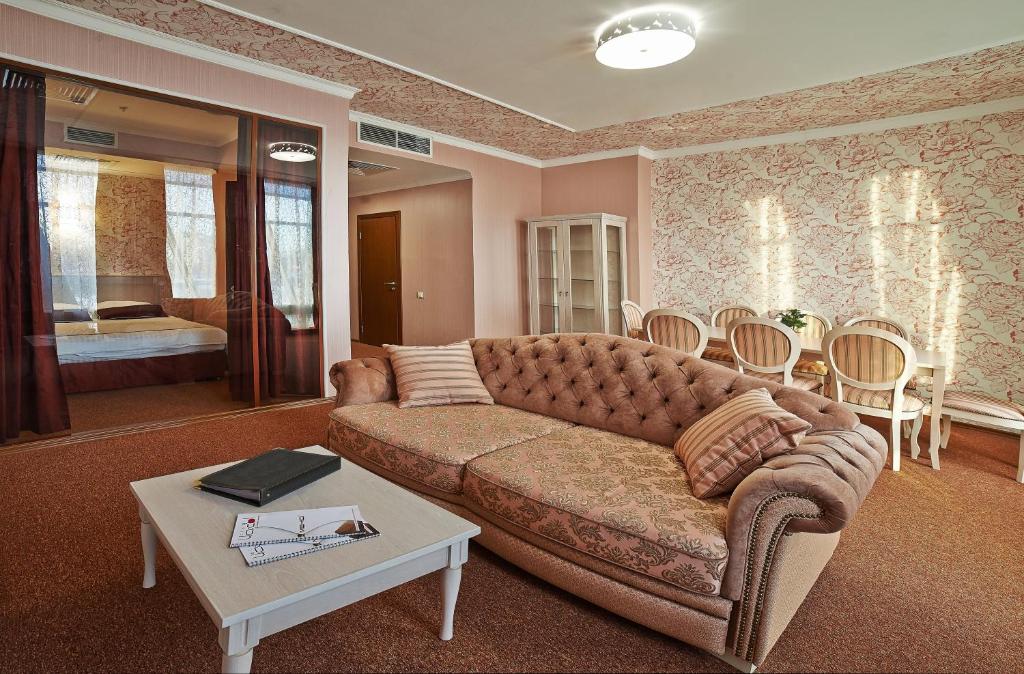 a living room with a couch and a table at Aer Hotel in Belgorod
