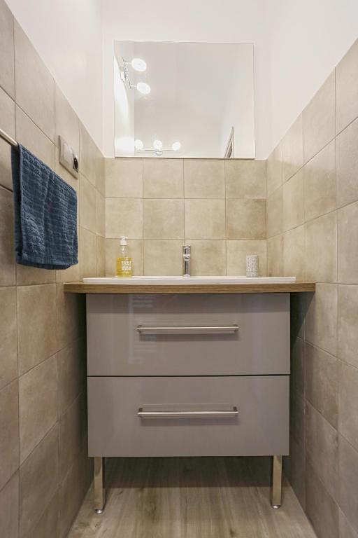 a bathroom with a sink and a mirror at SunRise Cassis in Cassis