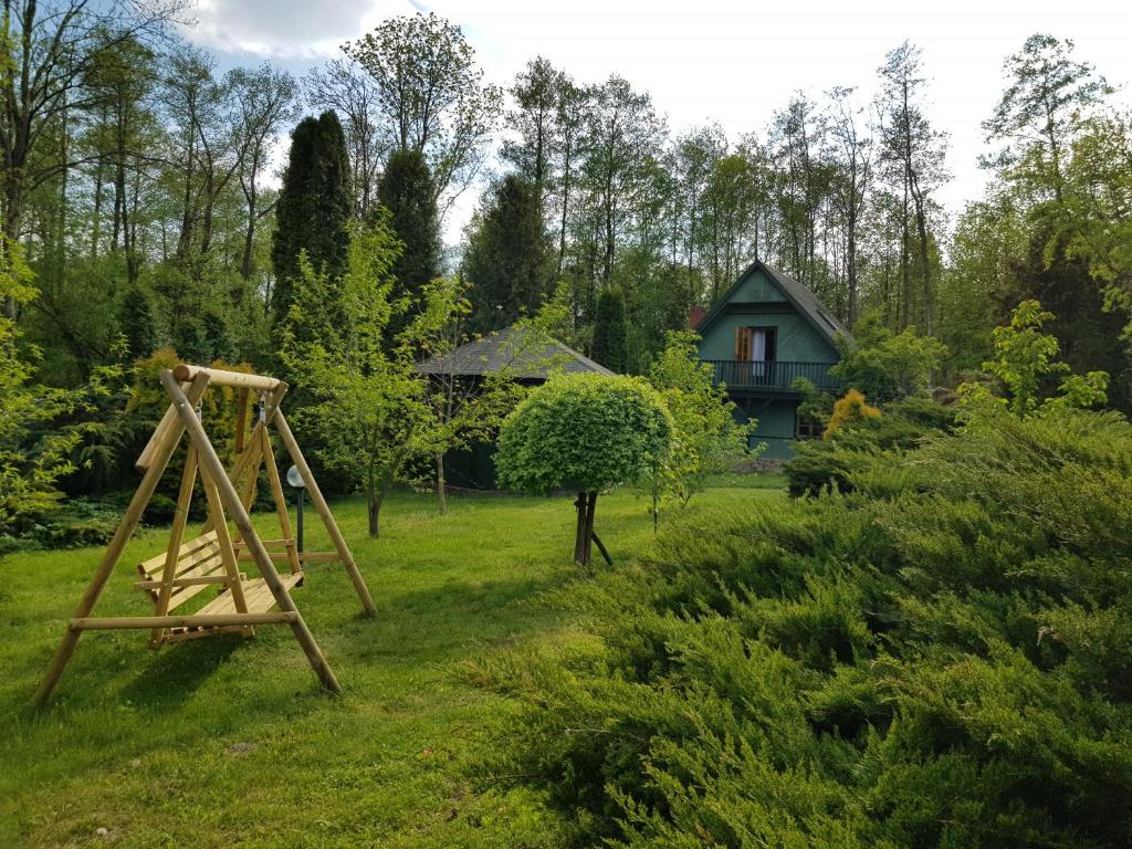 a swing set in the yard of a house at Domek w otulinie Wigierskiego Parku Narodowego in Aleksandrowsk