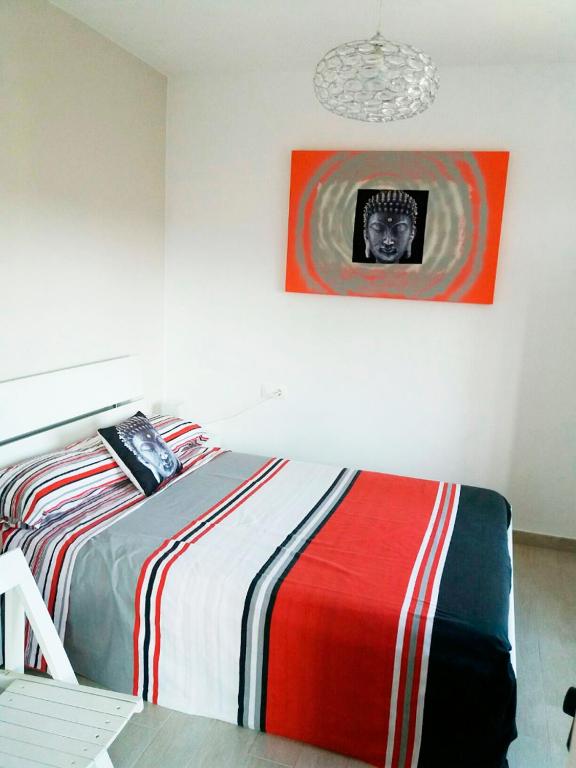 A bed or beds in a room at Apartamentos Lorena 1A