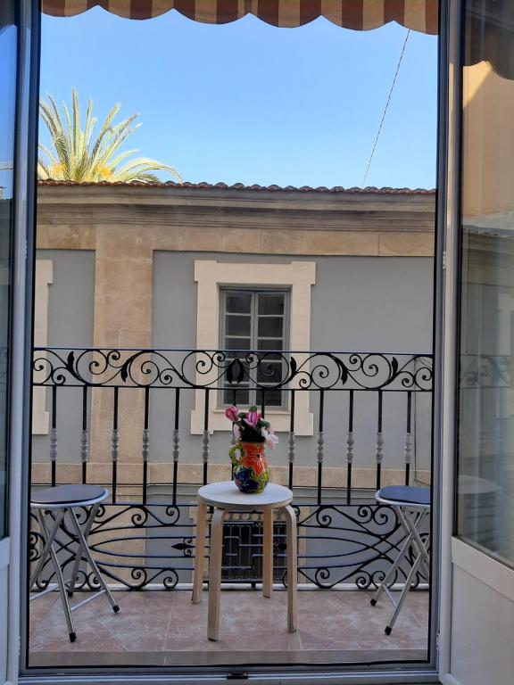 un jarrón de flores sentado en una mesa en un balcón en Modern Flat in Alicante en Alicante