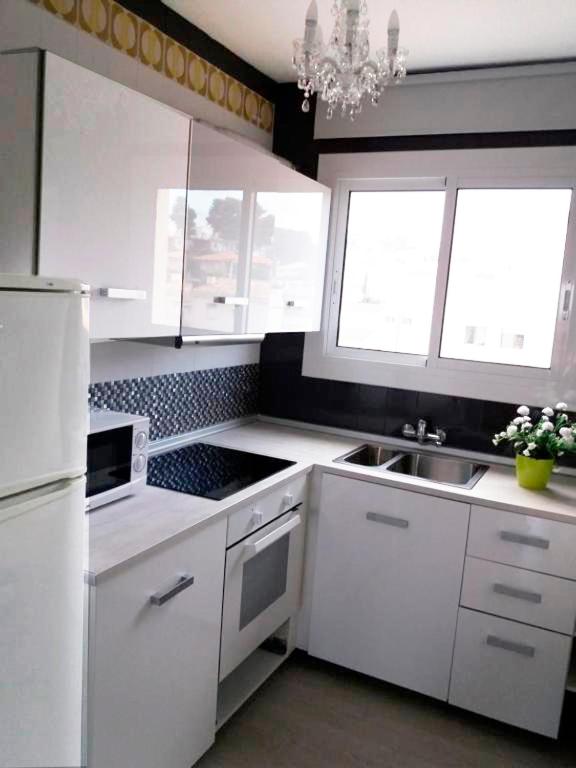 A kitchen or kitchenette at Apartamentos Lorena 1A