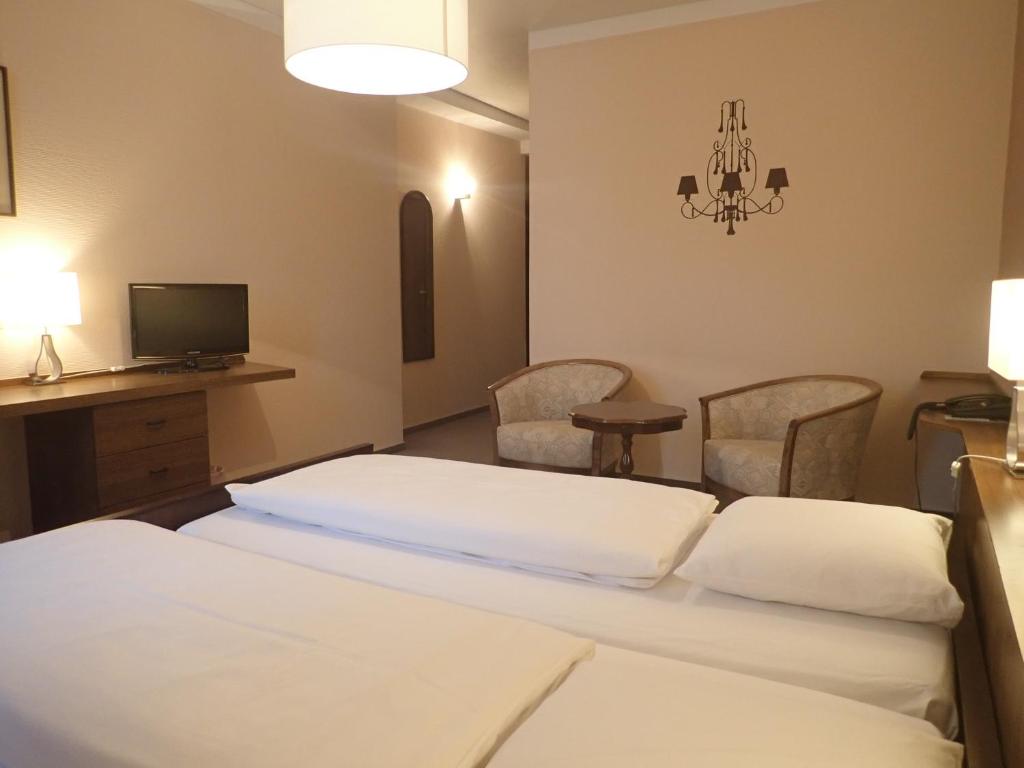 Postel nebo postele na pokoji v ubytování Hotel du Parc