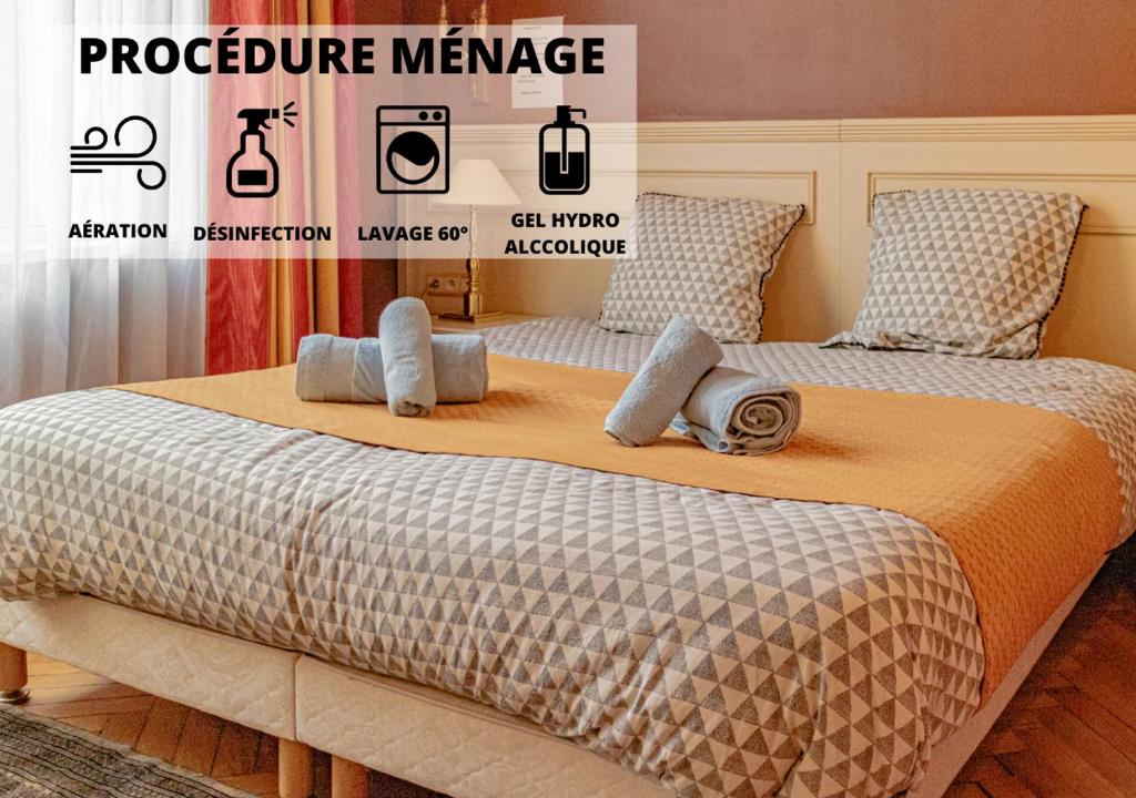 a bedroom with two beds and a sign that says procedure maintenance at Cosy'Appart - TY BOUQUET in Rouen