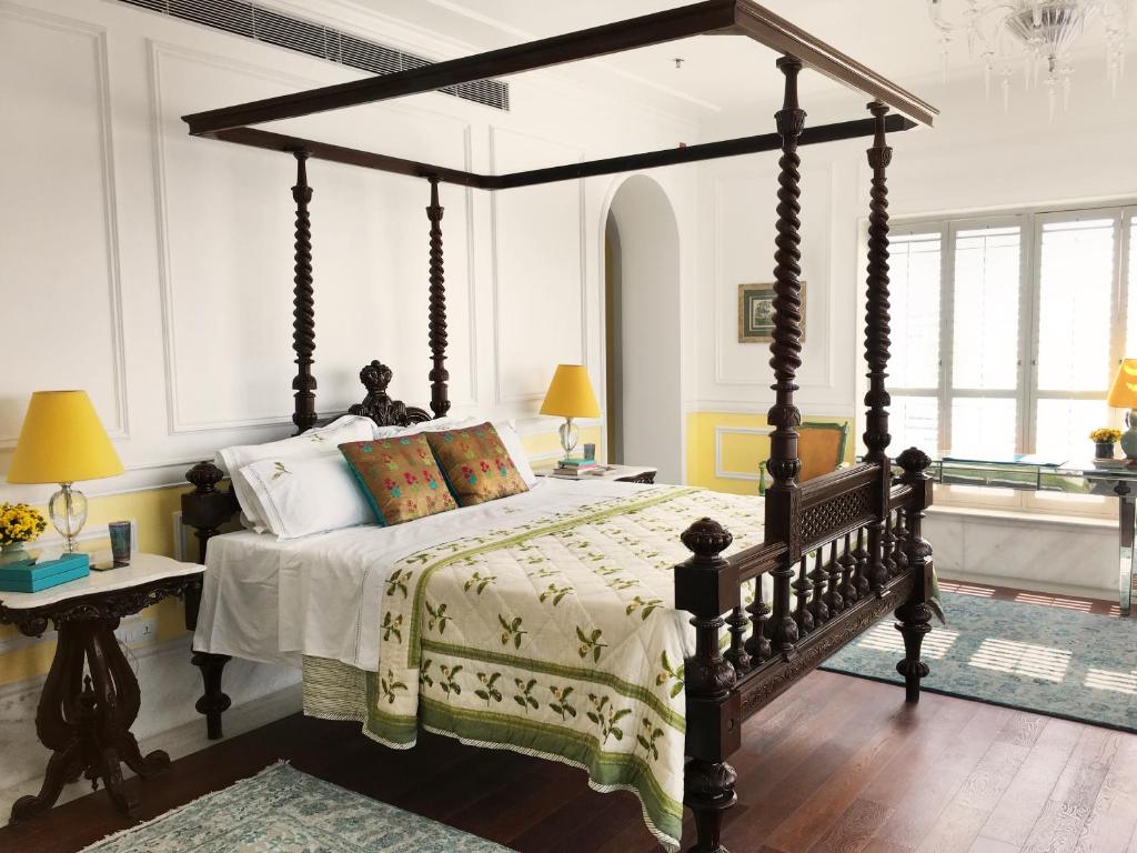 a bedroom with a large bed with a canopy at The Glenburn Penthouse in Kolkata