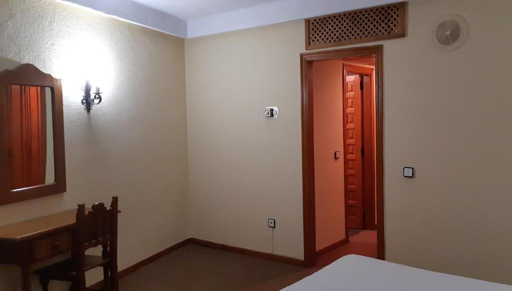 a room with a door leading to a hallway at San Glorio in Llánaves de la Reina