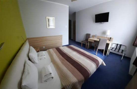 Postel nebo postele na pokoji v ubytování Hotel Arsenał