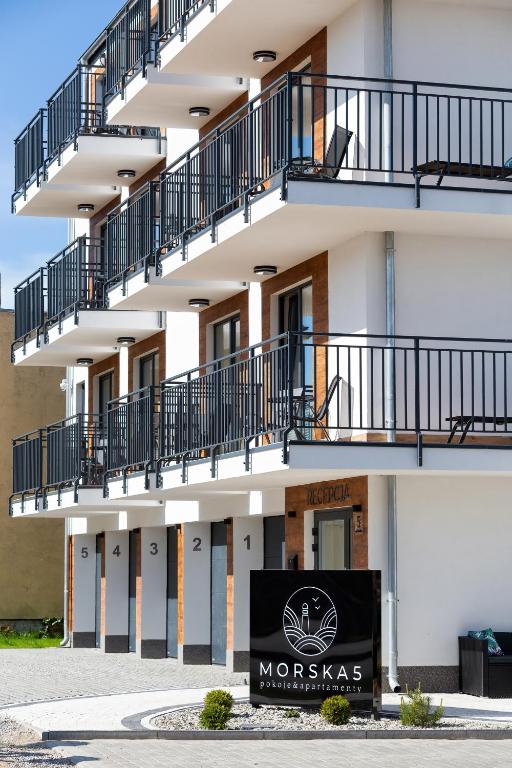 a building with balconies and a sign in front of it at Morska 5 in Niechorze