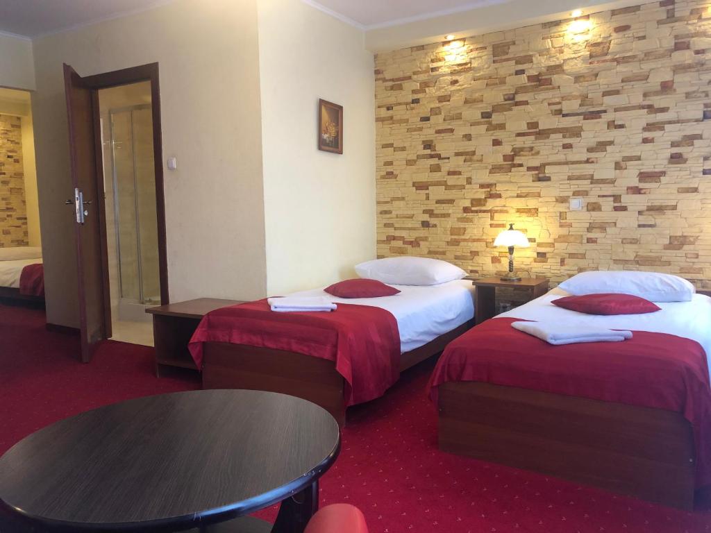 Posteľ alebo postele v izbe v ubytovaní Hotel Sekwana