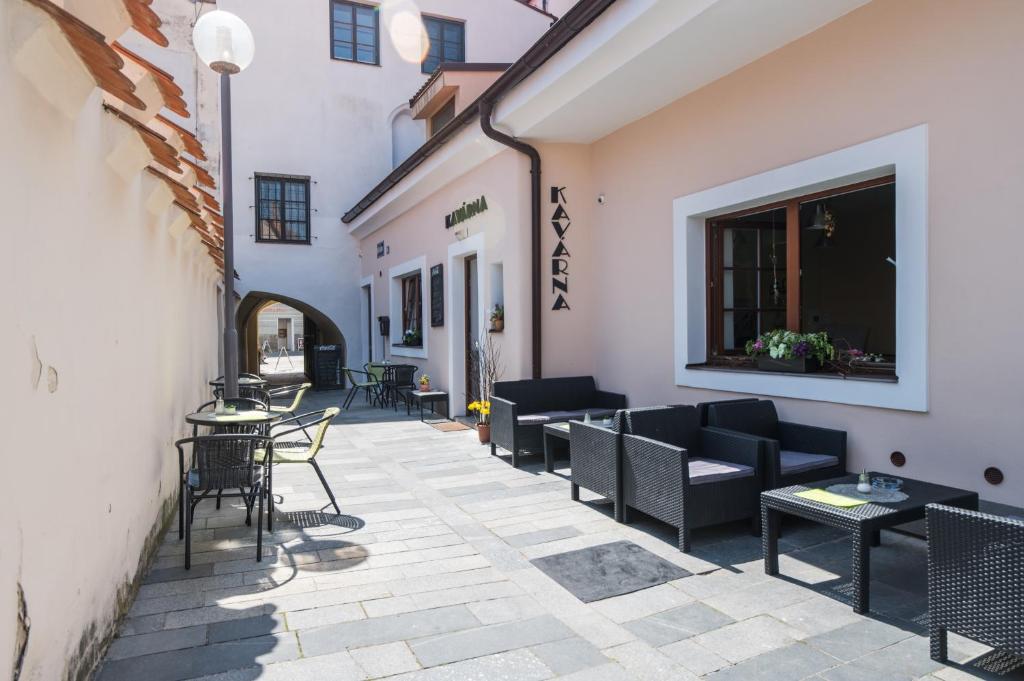 a patio with chairs and tables in a building at Apartman Masné krámy Třeboň in Třeboň