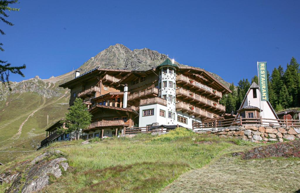 a large building on the side of a mountain at Hotel Silbertal in Sölden