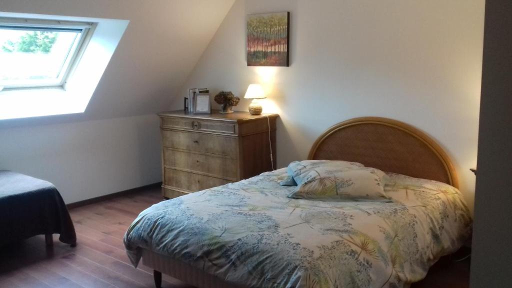 a bedroom with a bed and a dresser and a window at Domaine de l'Etre in Saint-Pierre-du-Regard